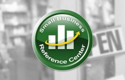 The photo shows the logo of the Small Business resource. There is a grey background. In the center is a green circle with a small bar graph and an arrow bending upwards suggesting growth.